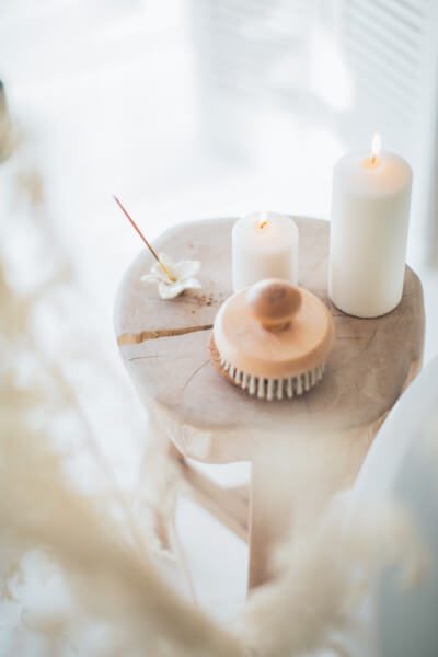 candles and massage brush on table tao wellness med spa